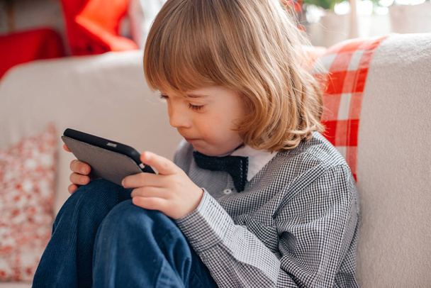 little boy playing on smartphone at home  - Fotografie, Obrázek