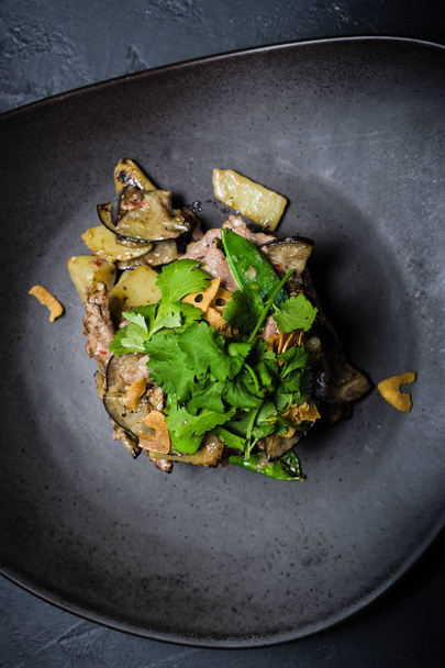 Salad with baked beef tenderloin and eggplant, dark background - Valokuva, kuva