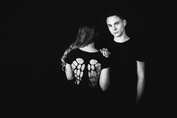 young lovely couple posing in studio on black background  - Φωτογραφία, εικόνα