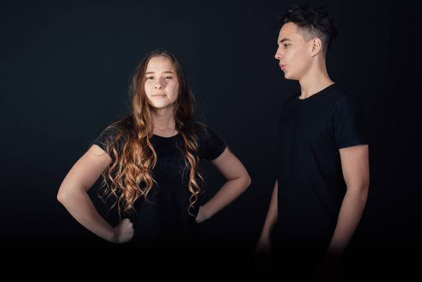 young lovely couple posing in studio on black background  - Foto, Bild