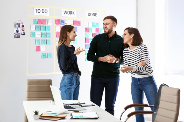 Young business people near scrum task board in office - Photo, Image