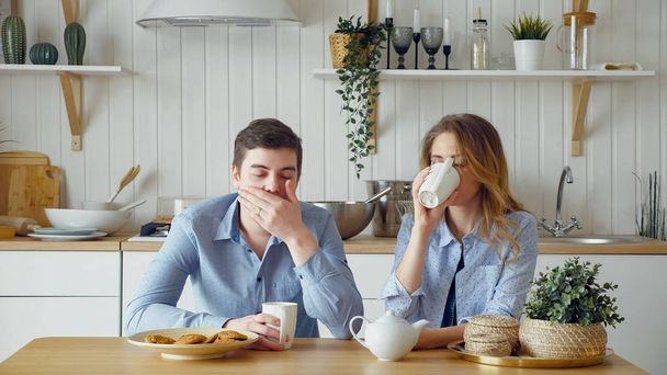 sad couple girl guy have breakfast drinking tea silently - Photo, Image