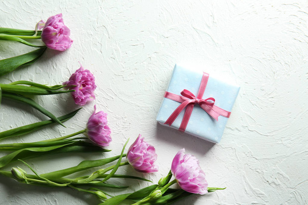 Gift box with beautiful tulips on white textured background - Fotó, kép