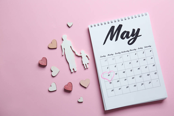 Calendar with reminder of Mother's Day on color background - Foto, imagen