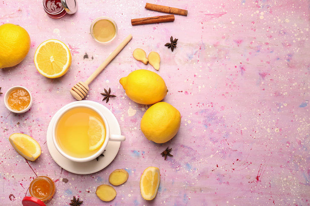 Cup of tasty tea with lemon, ginger and honey on color background - Fotó, kép