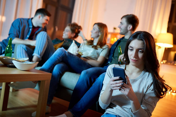 young woman with smartphone at home party - Foto, Imagem