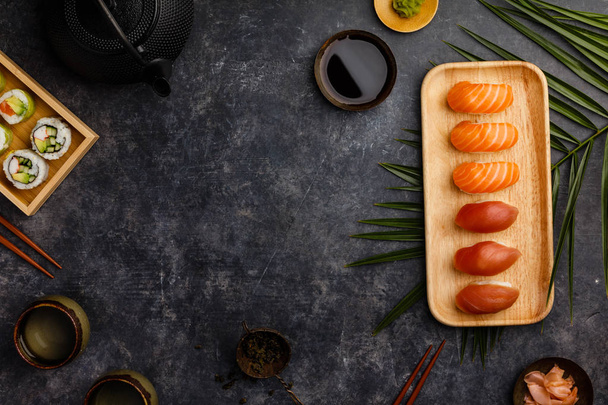 Nigiri sushi set with salmon and tuna served on bamboo plate - Fotó, kép