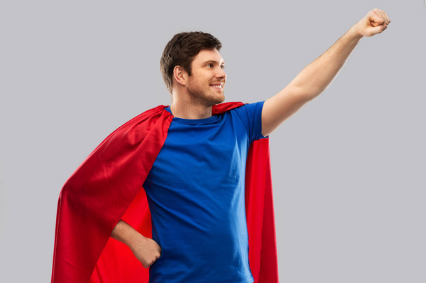 man in red superhero cape over grey background - Photo, Image