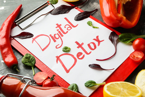 Clipboard with text DIGITAL DETOX and fresh vegetables on dark background - Photo, Image