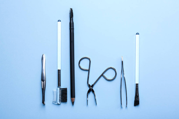 Set of tools for eyebrows correction on color background - Photo, image