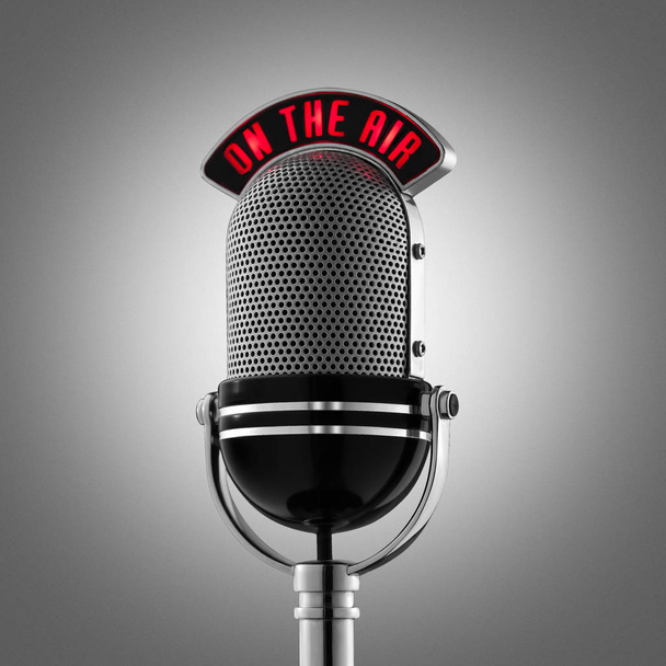Classical retro microphone on the air on grey background - Photo, Image