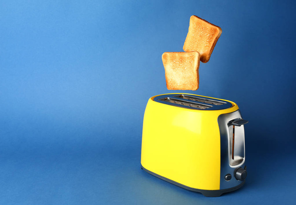 Toaster with bread slices on color background - Photo, Image