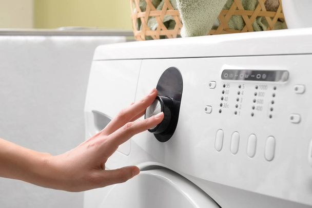Woman switching on washing machine, closeup - Foto, Imagen