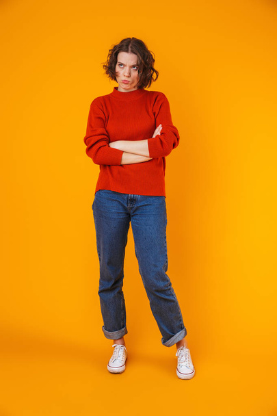 Angry displeased young pretty woman posing isolated over yellow wall background. - Foto, Imagem