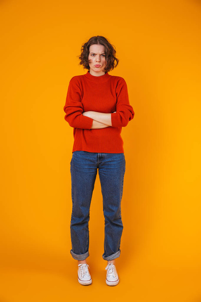 Angry displeased young pretty woman posing isolated over yellow wall background. - Фото, зображення