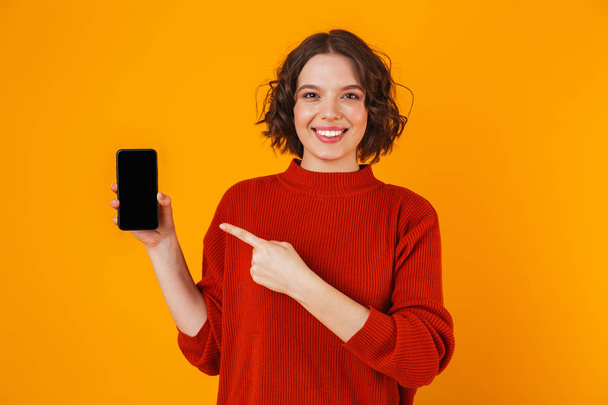 Portrait of european woman holding and demonstrating smartphone  - Photo, image