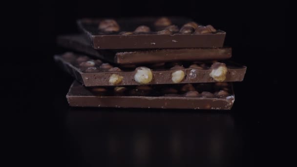 Bloques de chocolate negro con detalles de frutos secos macro de primer plano lento. Perspectiva hecha de barras de chocolate
 - Metraje, vídeo