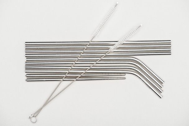 top view of stainless steel straws and cleaning brushes isolated on grey - Photo, image