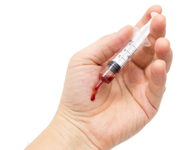 syringe in hand on white background - Foto, Imagen