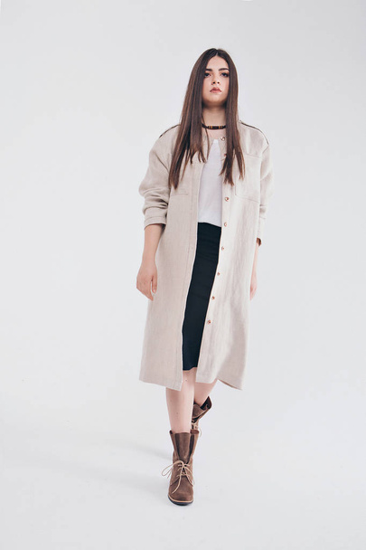 beautiful girl in long linen coat on white background. Model in advertising clothing - Fotografie, Obrázek