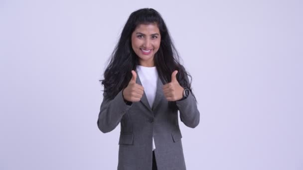 Young happy Persian businesswoman looking excited and and giving thumbs up - Séquence, vidéo