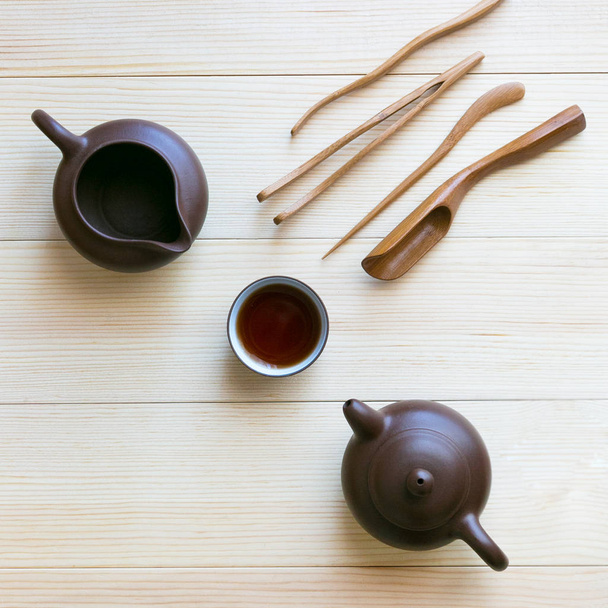 A set accessories for the tea ceremony. Dishes for tea wooden sticks on a light background. - Photo, image