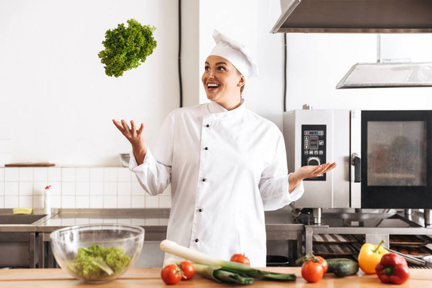Photo of european woman chef wearing white uniform cooking meal  - Photo, image