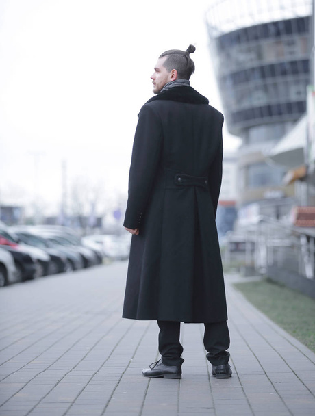 young business man in a winter coat standing on the street - Foto, Bild