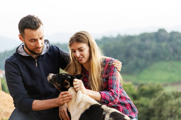 couple in love with a dog in the mountains - Foto, Imagen