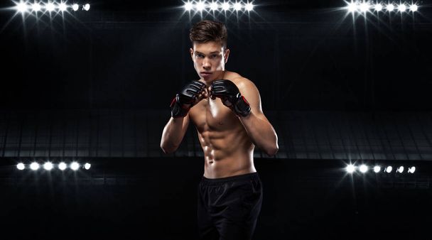 Sportsman teenager boxer fighting on black background with shadow. Copy Space. Boxing sport concept. - Фото, зображення