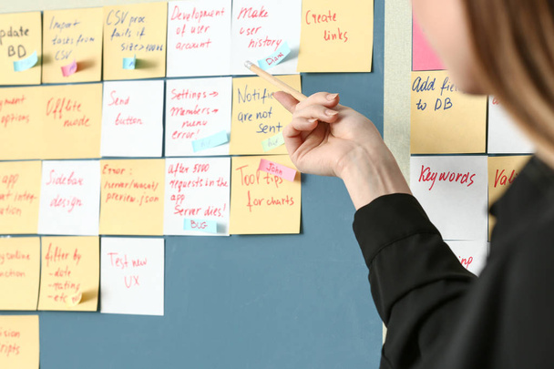 Young woman near scrum task board in office - Photo, Image