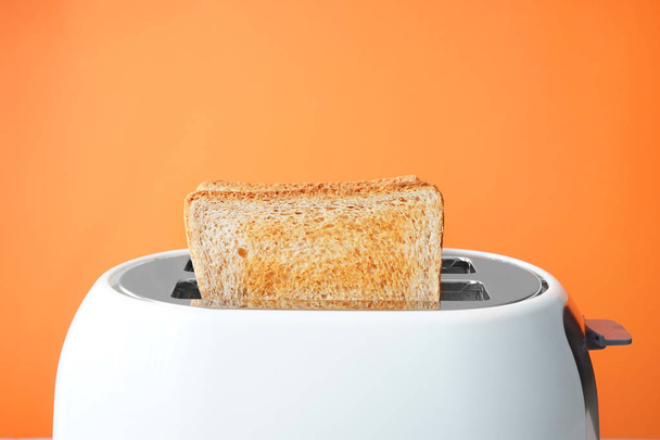 Slices of bread with toaster on color background - Photo, Image