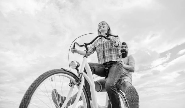 Youth have fun riding bike sky background. Enjoy summer holidays vacation riding bike. Couple in love happy cheerful enjoy cycling together. Happy moments. Active leisure tips. Summer holidays ideas - Fotografie, Obrázek