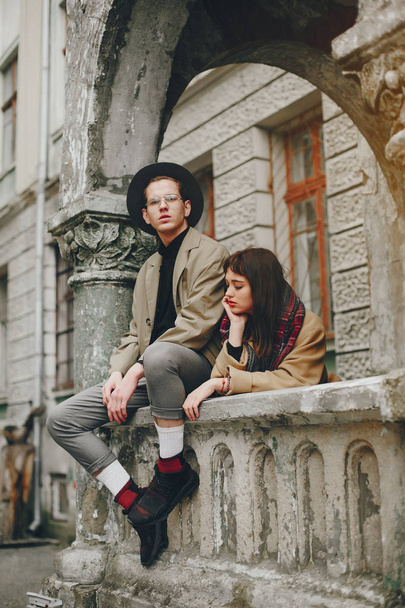 A trendy couple in a gloomy city - 写真・画像