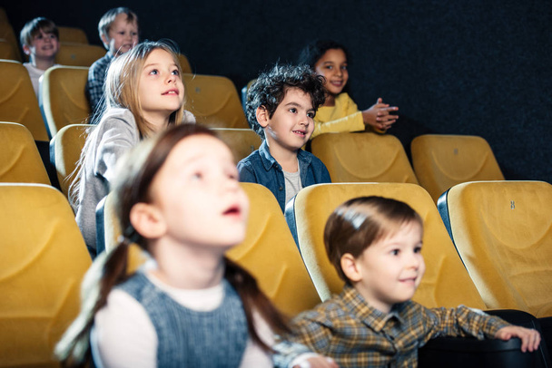 selective focus of multicultural friends watching movie in cinema - Fotoğraf, Görsel