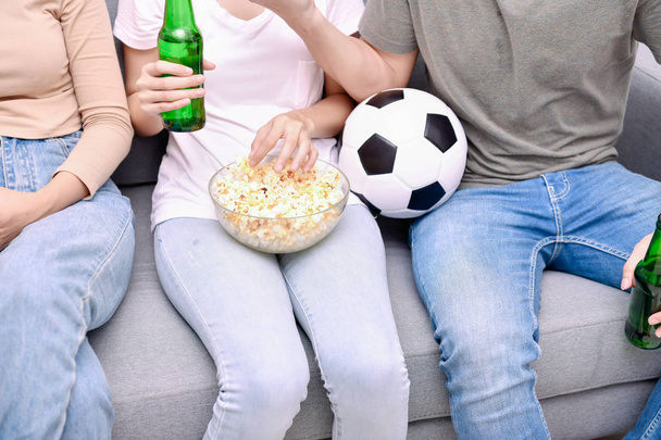 Concept of cheering. Asian teenagers watching football on televi - Fotó, kép