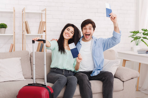 Ready for trip. Happy couple showing passports and tickets - Photo, Image