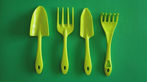 Set of green garden tools on green background - Photo, image