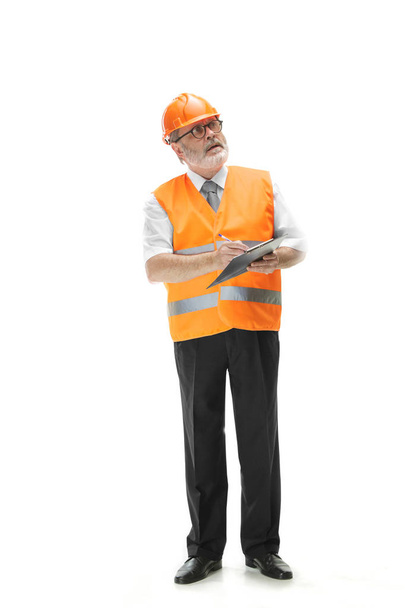 The builder in orange helmet isolated on white - 写真・画像
