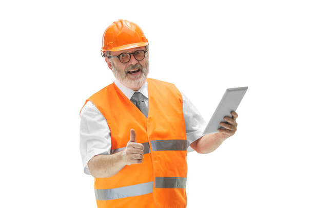 The builder in orange helmet isolated on white - Фото, изображение