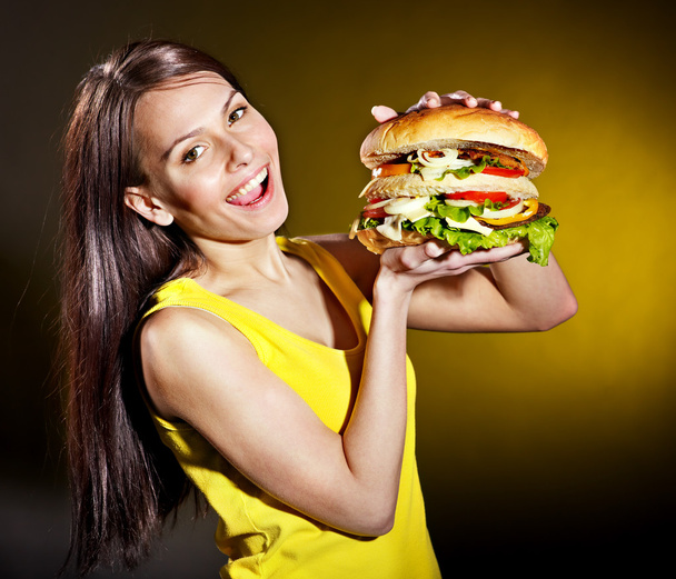 Woman holding hamburger. - Photo, Image