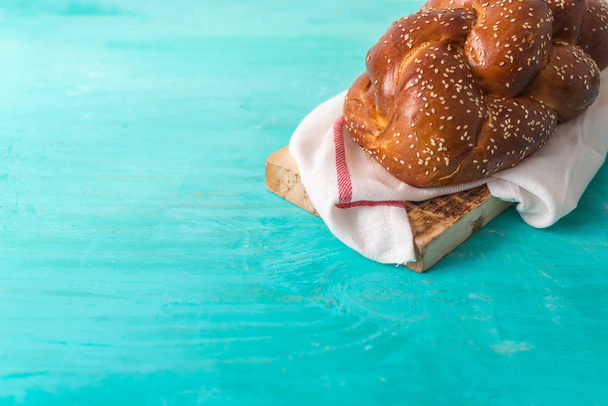 Challah bread on a wood plate on wooden table / white background with copy space - 写真・画像