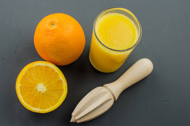 Orange juice on a black background - Photo, Image