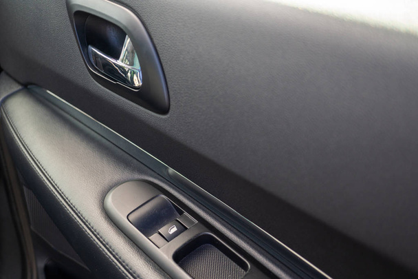Car interior details of door handle with windows controls. Car window controls and details - Zdjęcie, obraz