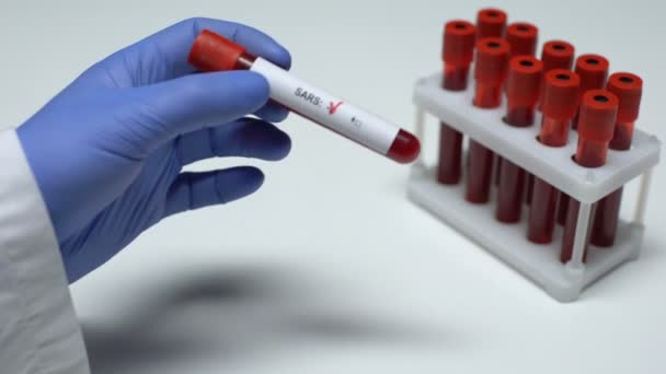 Negative SARS test, doctor showing blood sample, lab research, health checkup - Filmagem, Vídeo