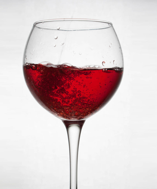 glass goblet on white background with  liquid splashing - Foto, Imagem