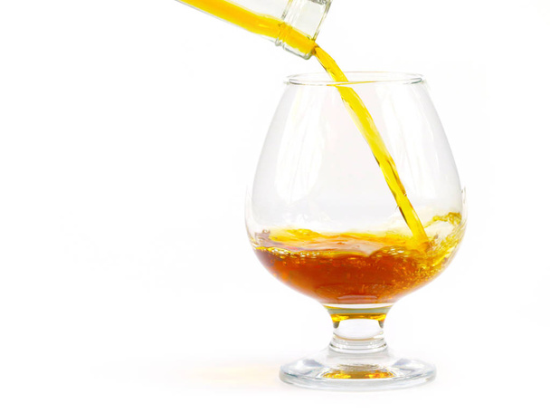 strong liquor when pouring into a glass creates elegant bursts - Valokuva, kuva