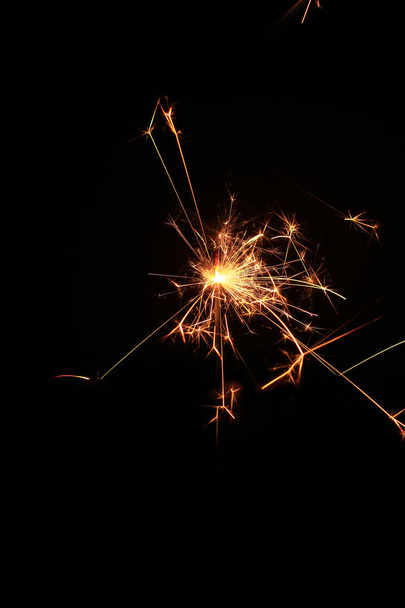 yellow sparks on a black background - 写真・画像