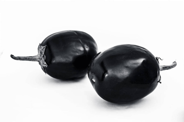 Close up of fresh organic egg plant or bringal or Aubergines or brinjal or baingan or eggplant isolated on white. - 写真・画像
