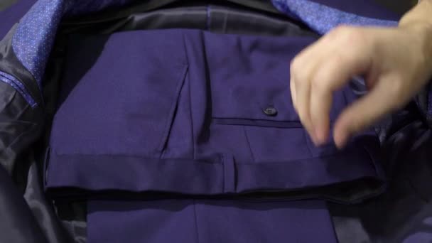 Packing blue jacket and blue man suit - Video, Çekim
